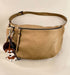 Large beige leather pouch with a zipper and a cute dog charm accessory.